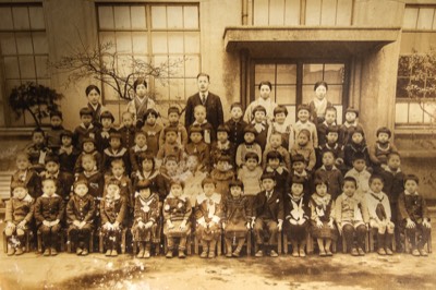  Elementary school class portrait. He is in the top row of students, seconf from left. 