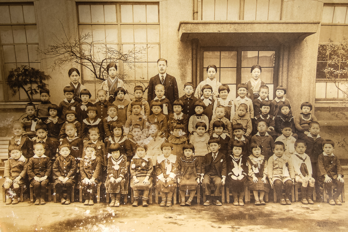  Elementary school class portrait. He is in the top row of students, seconf from left. 